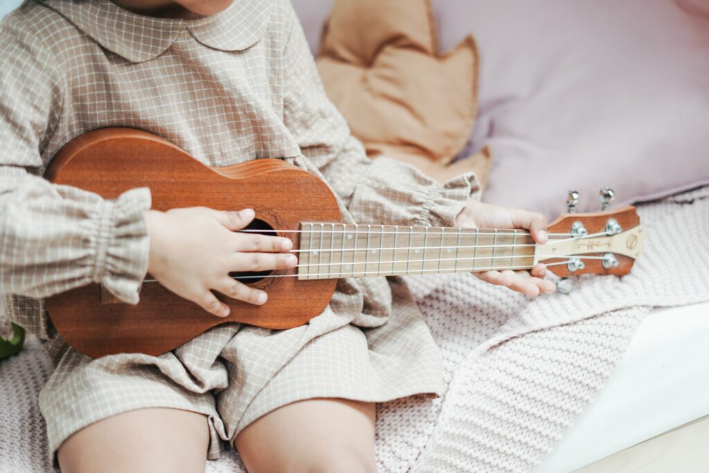 Little girl with wooden guitar